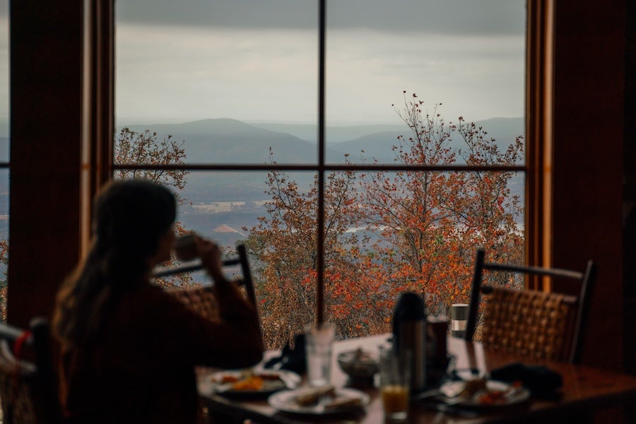 woman eating on the lodge restaurant looking out the window