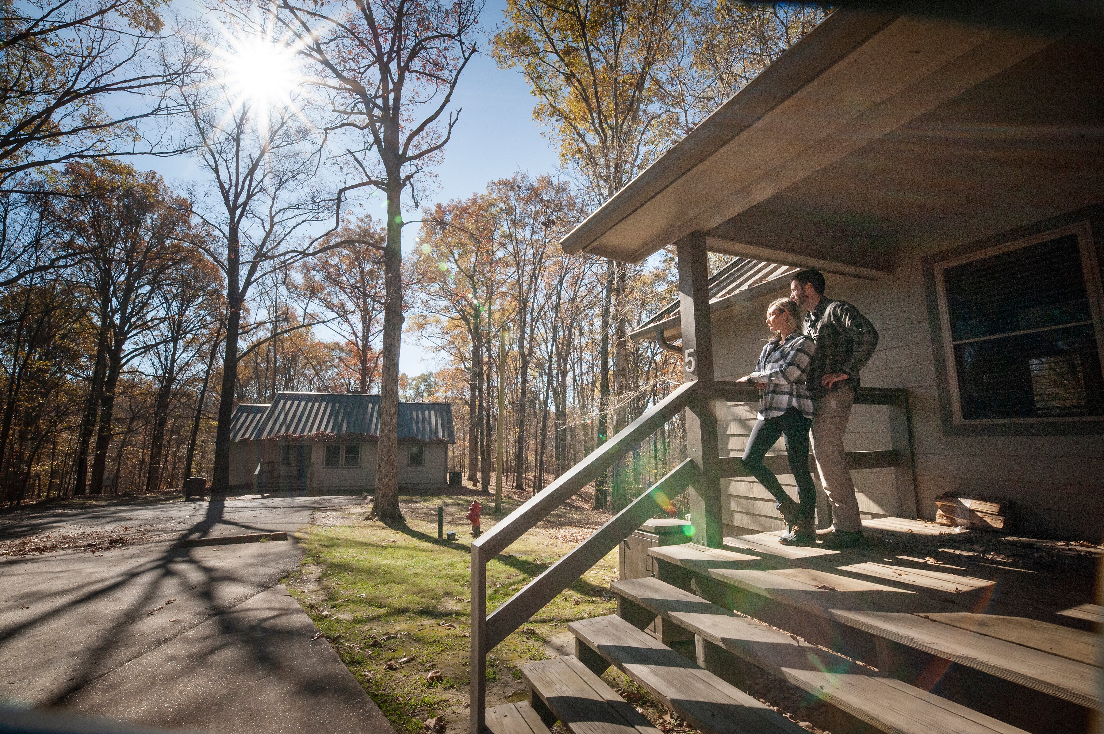Couple standing on porch of Village Creek State Park cabin